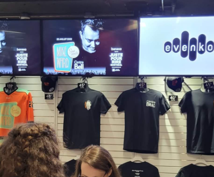 Mike Ward Sous Écoute merch booth at Bell Centre arena.